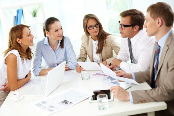 5 people sitting at a conference table